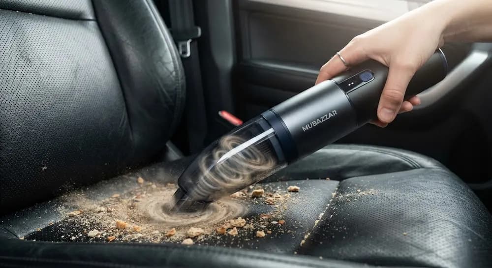 MUBAZZAR 4-in-1 cordless handheld car vacuum suctioning sand and crumbs from leather car seats
